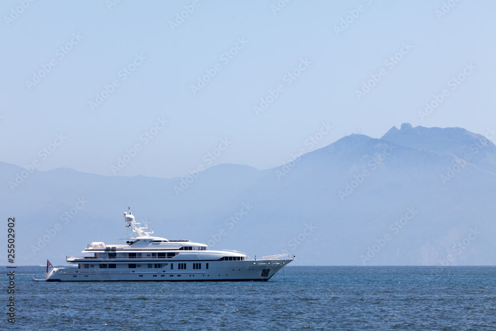 Cruising yacht in the sea on the background of mountains