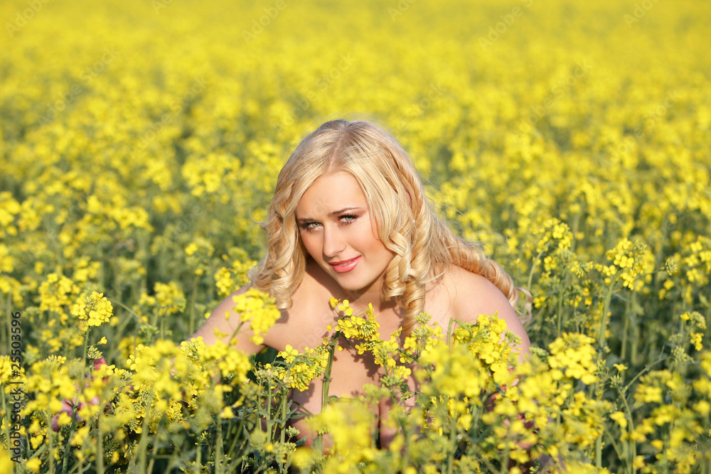 Beautiful young blonde woman in a field of wildflowers. Beautiful young blonde woman in a field of wildflowers.