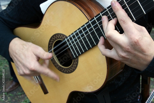 Man's hands plaing a guitar