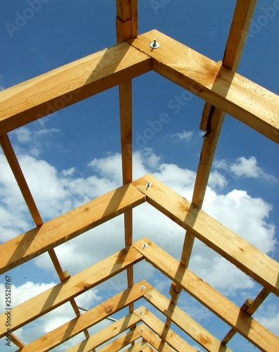 Roof under construction with blue sky and clouds