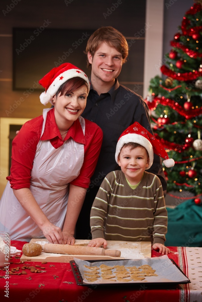 Happy family baking christmas cake together Happy family baking christmas cake together