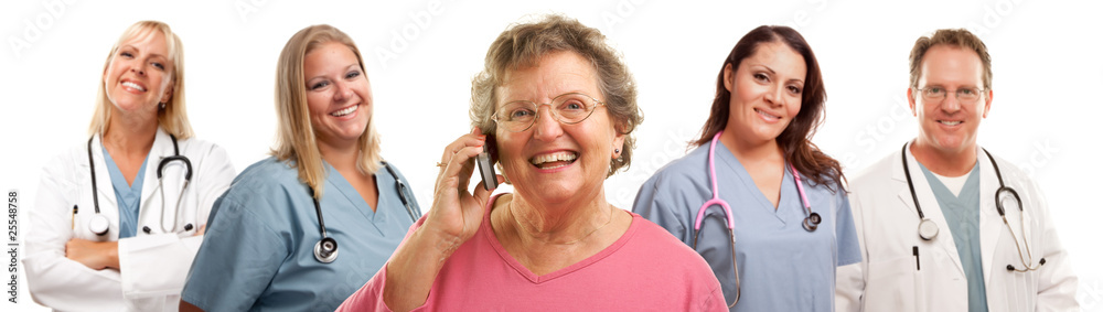 Happy Senior Woman Using Cell Phone and Doctors Behind Happy Senior Woman Using Cell Phone and Doctors Behind