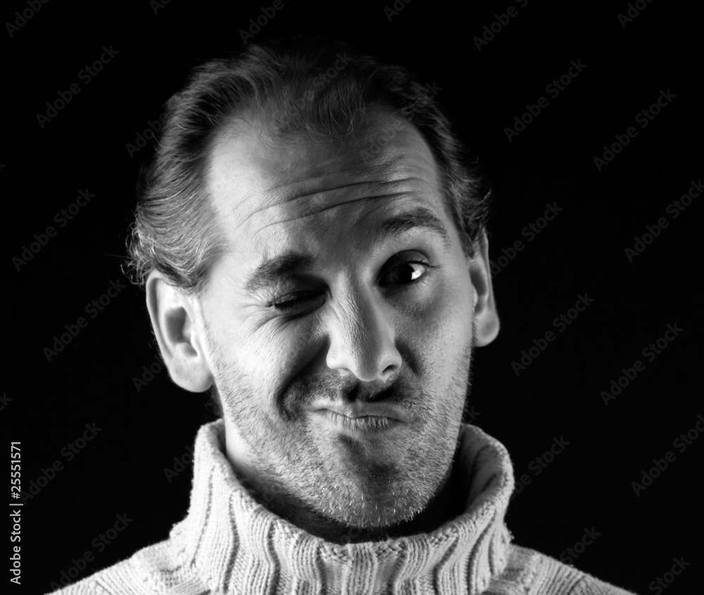 Adult man portrait cheerful wink expression on black and white