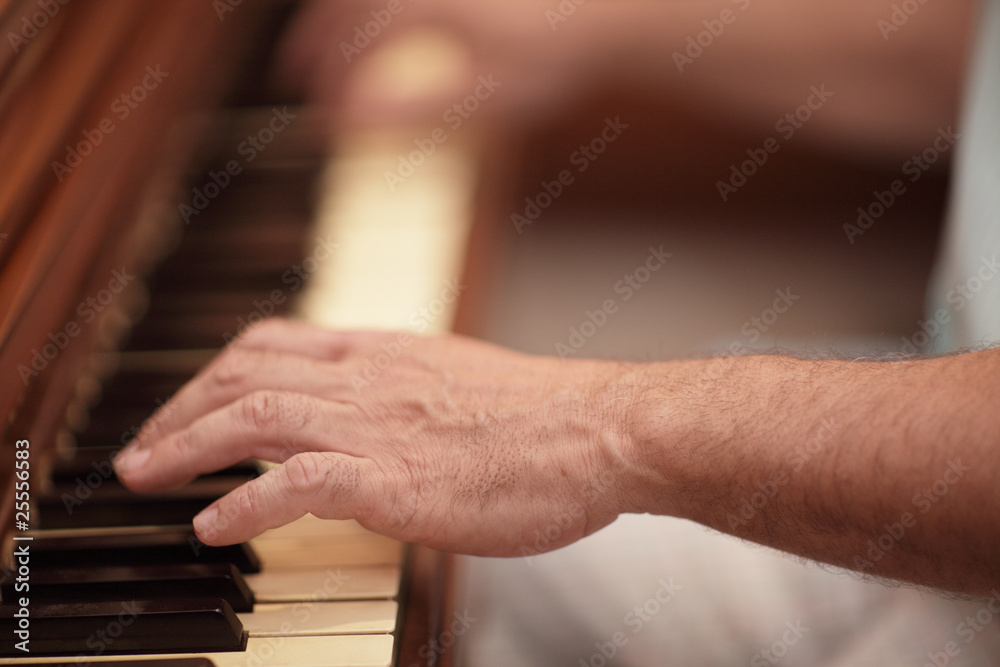 Hand playing the piano