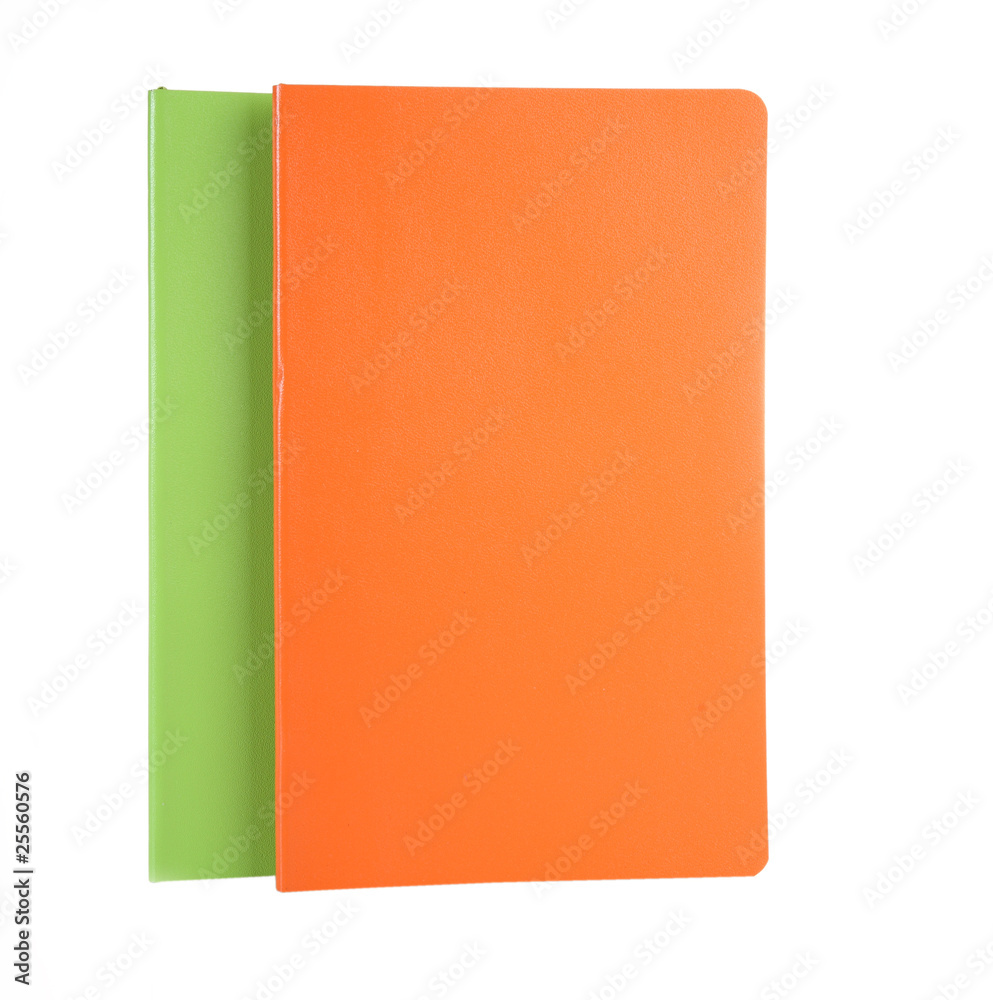 Orange and green writing-books on a white background Orange and green writing-books on a white background