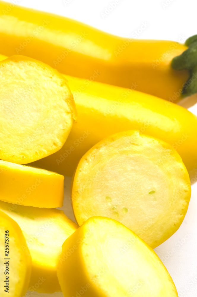 two yellow zucchini squash with slices