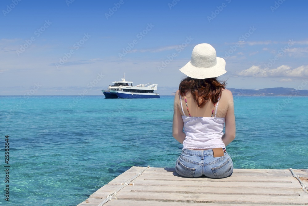 Tourist back woman looking Formentera turquoise sea