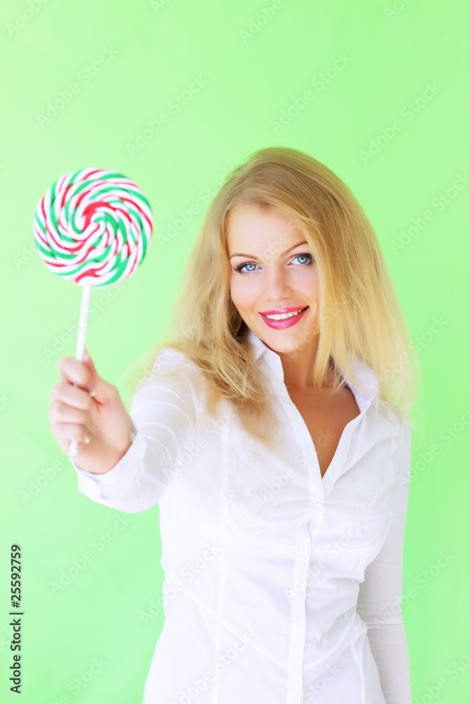 Beautiful girl holding lollipop