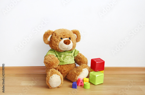Toys - Teddy bear with cubes on laminate floor