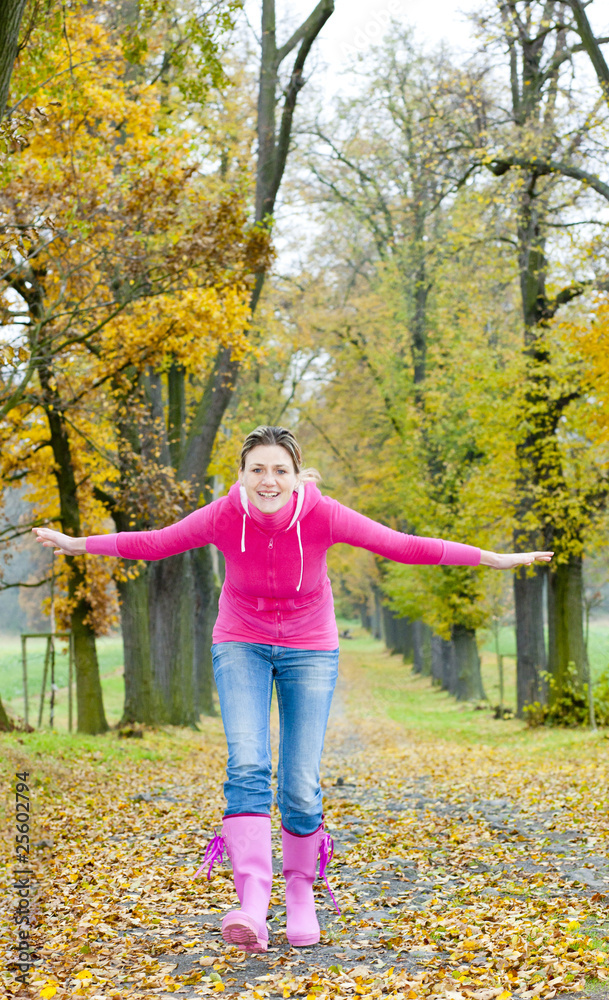 woman in autumnal alley woman in autumnal alley