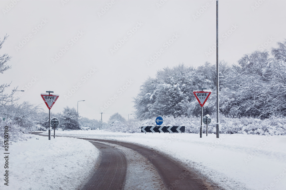 Fototapeta premium Road with give way signs in the snow