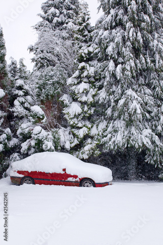 Red car covered in snow