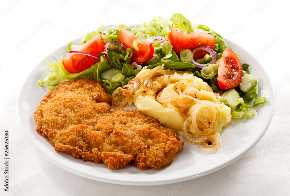 Fried pork chop with potatoes and vegetable salad Fried pork chop with potatoes and vegetable salad