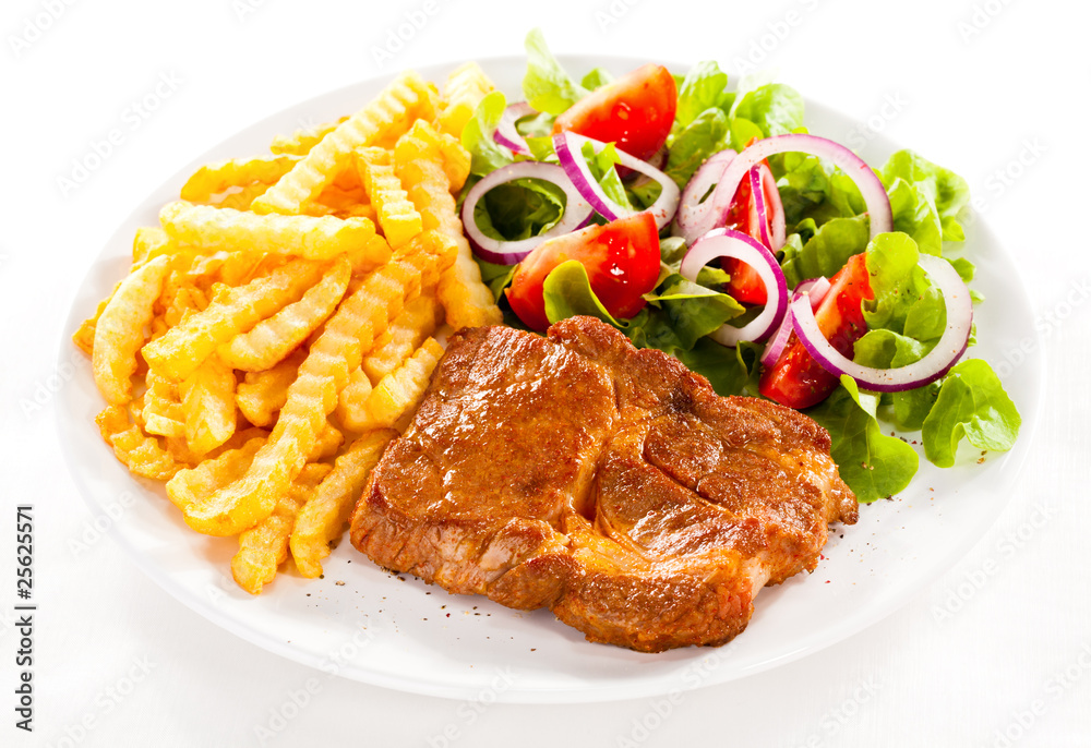 Grilled meat, French fries and vegetables Grilled meat, French fries and vegetables