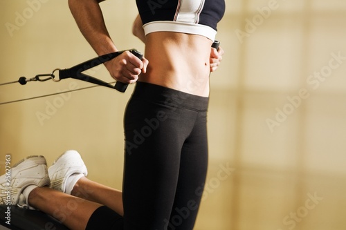 Torso Shot Of Young Woman Training In Gym