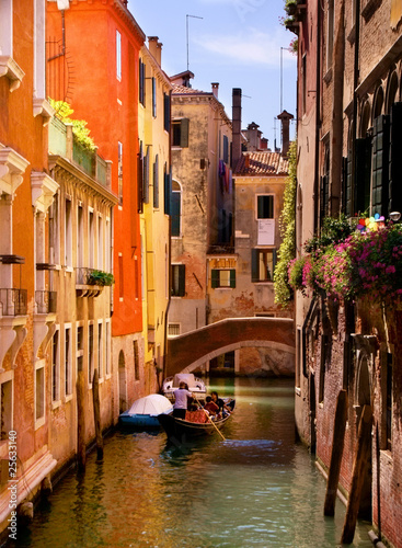 Wallpaper Mural A gondolier navigating one of the canals of venice