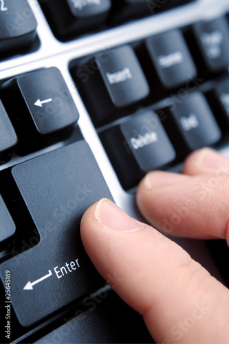 Finger on computer keyboard enter key