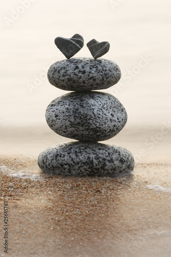 two stone hearts on a stone tower photo