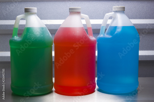 Gallon containers with colored liquid