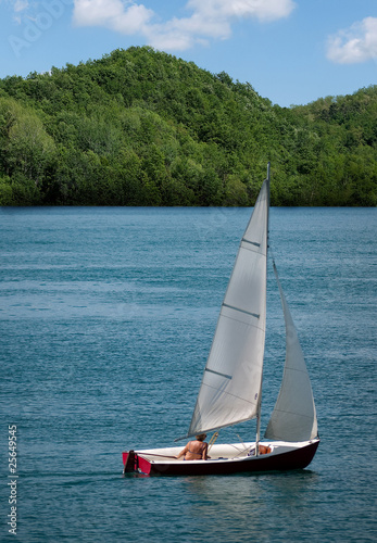 Middle aged woman sailing dinghy