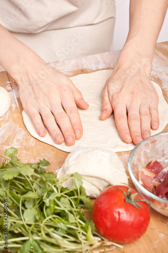 kneading dough on wooden surface