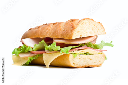 half of long baguette sandwich with lettuce, tomatoes, ham, turk