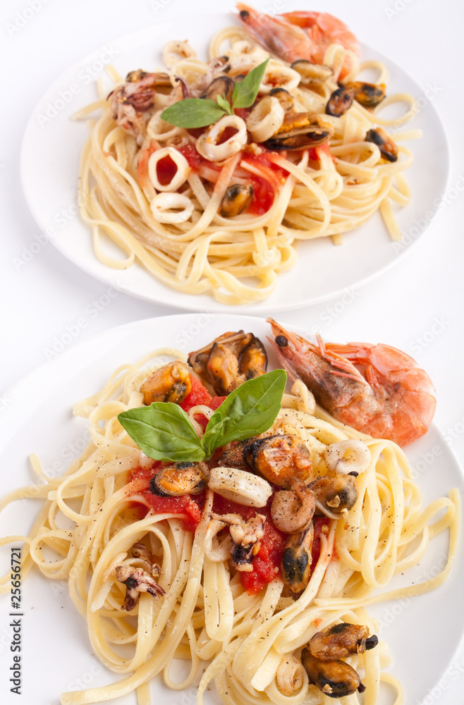 two servings of pasta with marinara sauce and seafood two servings of pasta with marinara sauce and seafood