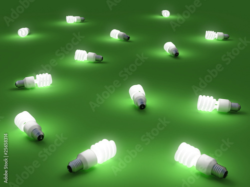 Lampadine fluorescenti accese su un piano verde photo