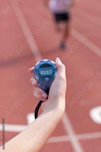 Close-up of a woman holding a chronometer to measure performance