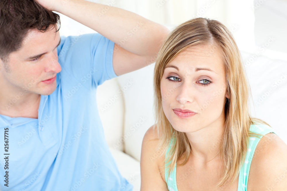 Young couple having an argue in the living-room Young couple having an argue in the living-room