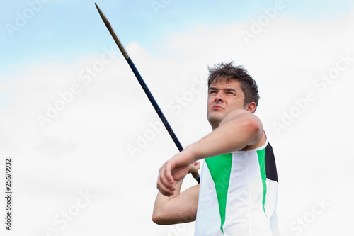 Determined sportsman throwing the javelin