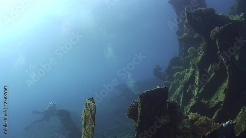 Scuba divers exploring a shipwreck photo