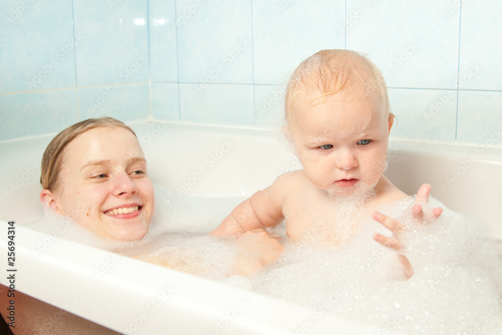 little baby play with bubbles in bath with mother little baby play with bubbles in bath with mother