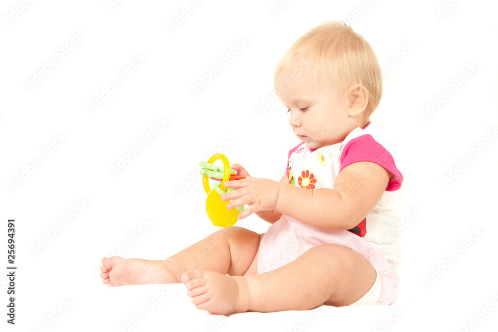 Happy cute baby girl (10 months) sitting on bed and playing with Happy cute baby girl (10 months) sitting on bed and playing with