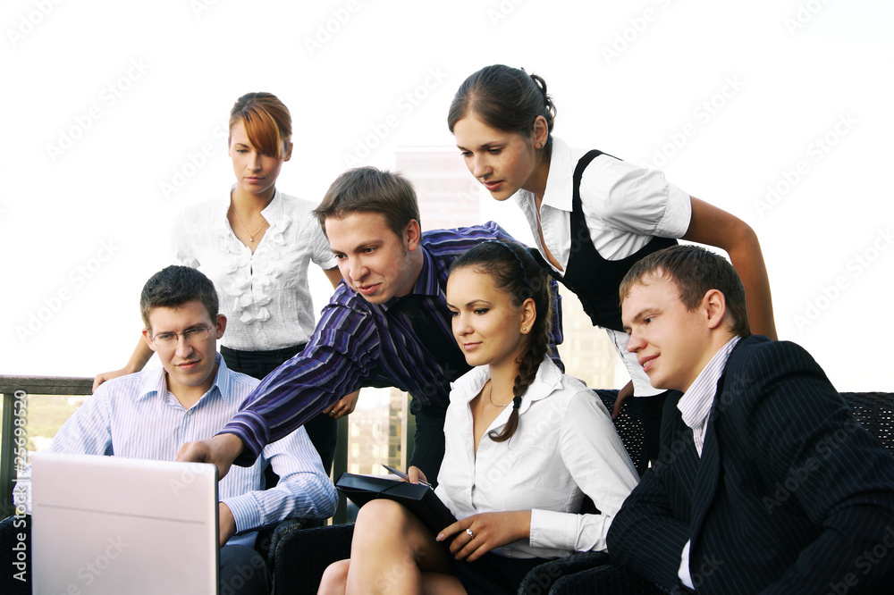 A group of six business persons is working with a laptop A group of six business persons is working with a laptop