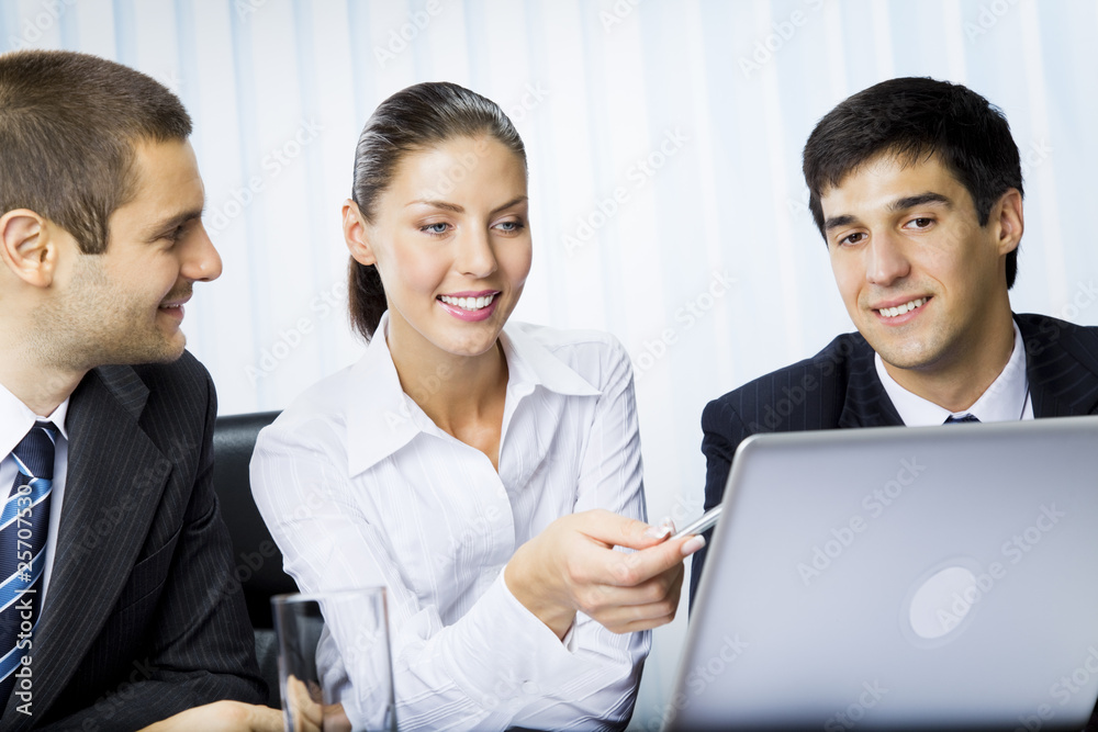Three businesspeople working with laptop at office Three businesspeople working with laptop at office