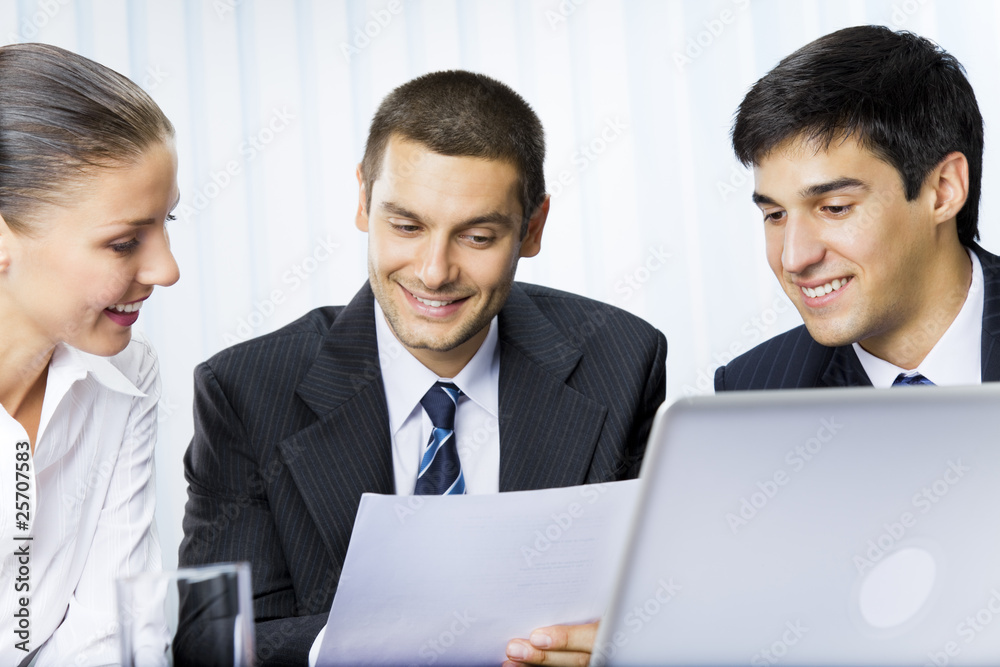 Three businesspeople working with document at office Three businesspeople working with document at office