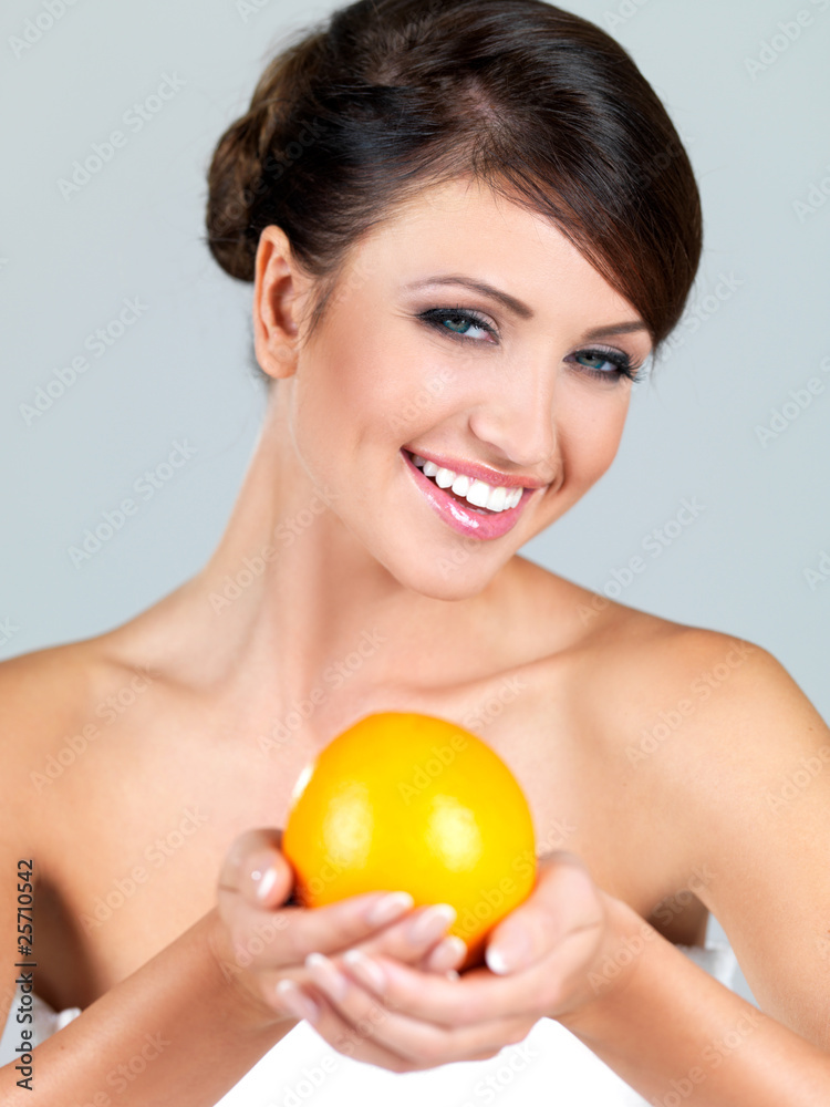 Portrait of beautiful woman, she holding fresh orange