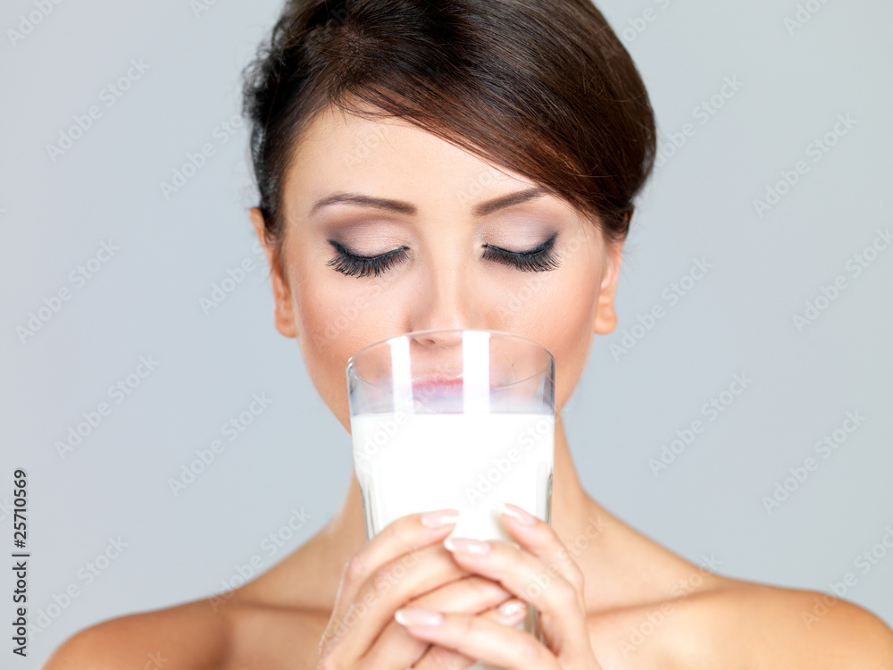 Portrait of beautiful woman, she holdin glass of milk Portrait of beautiful woman, she holdin glass of milk