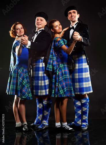 Two pairs dancing the Scottish dance in a kilt