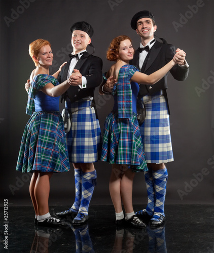 Two pairs dancing the Scottish dance in a kilt