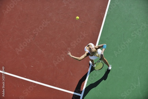 young woman play tennis outdoor © .shock