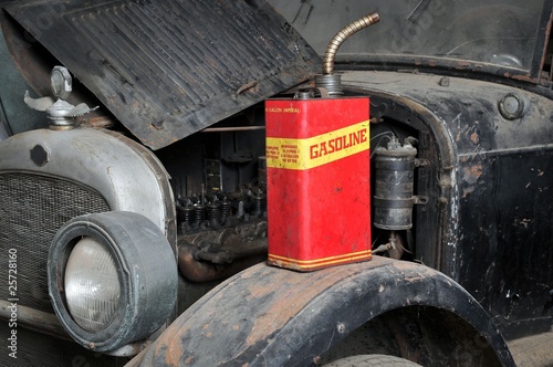 Vintage retro gas can isolated on old car photo