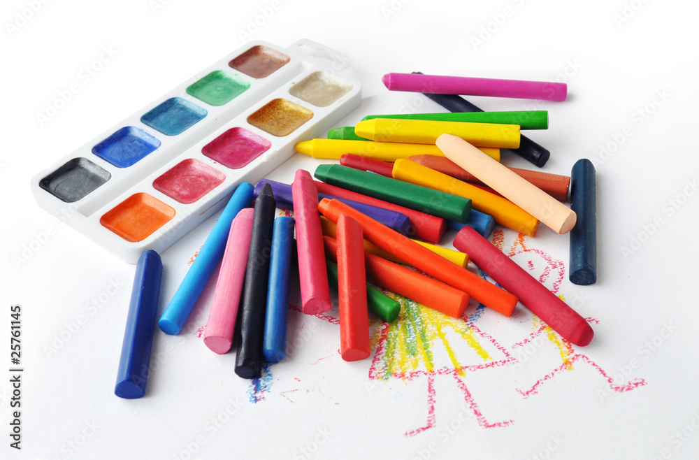 Watercolours and heap of colourfull crayons on white background