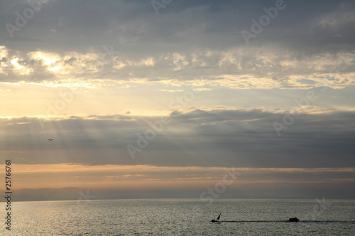 Diver in the sea in romantic sunset. Sardinia, Italy. © Elena Kovaleva