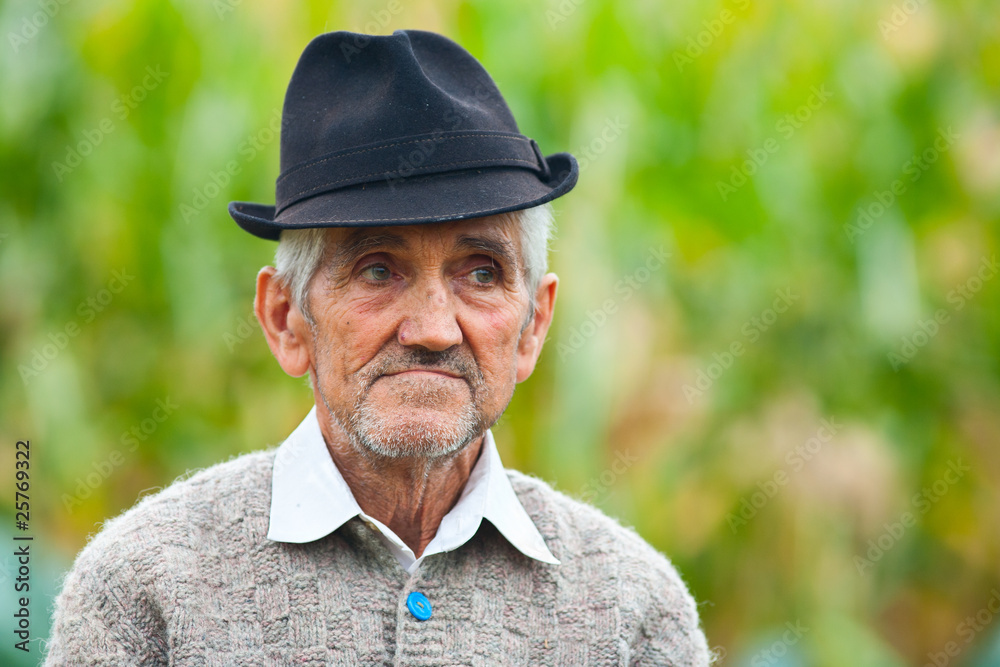 Portrait of a wrinkled and expressive old farmer outdoor