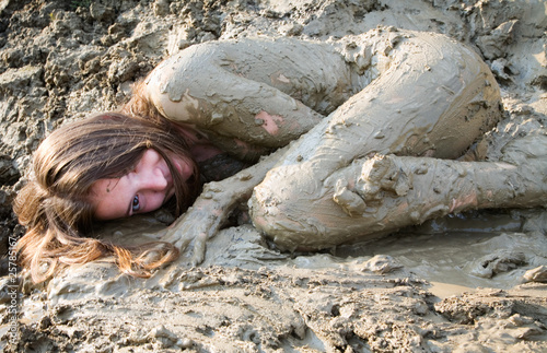 Naked girl lying in the dirt photo