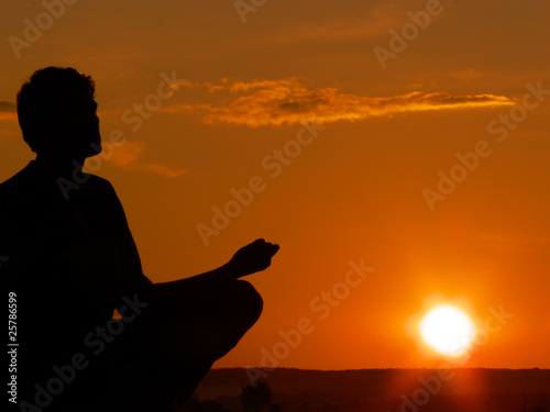 meditating at sunset