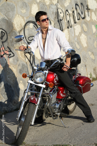 young man on a red motorcycle
