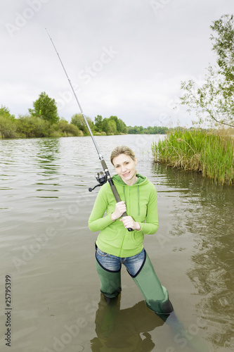 woman fishing in pond photo